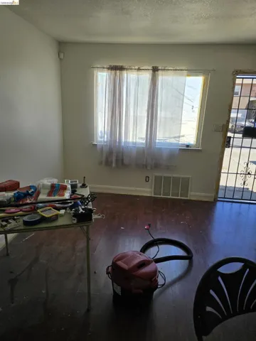 Room featuring wood-finish flooring and a large window
