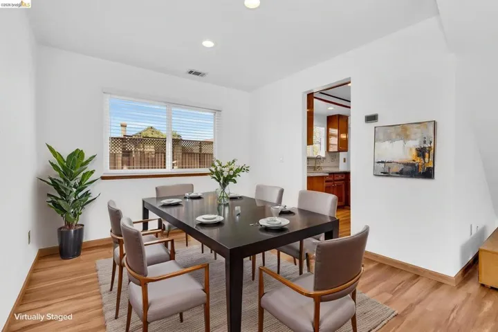 Dining area featuring wood-finish flooring, recessed lighting, and a window with horizontal blinds