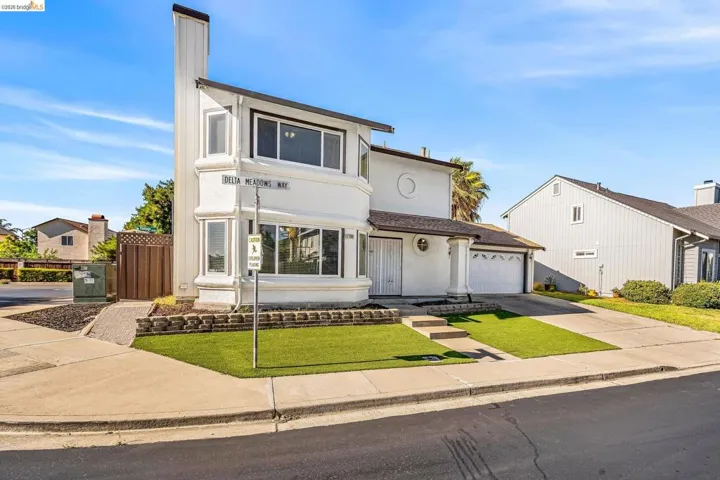 Contemporary two-story residence featuring a distinctive chimney design and multiple large windows