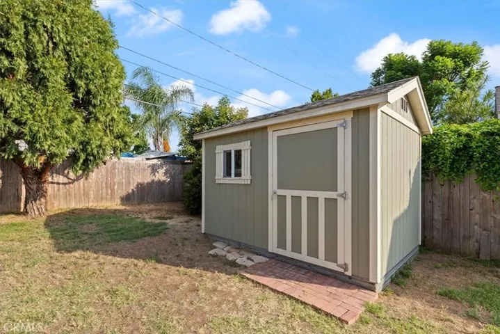 Gardening shed or extra storage in backyard.