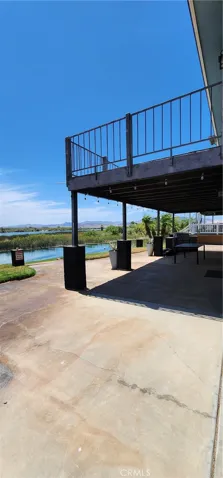 Side view of the back patio and upstairs deck, facing toward the water