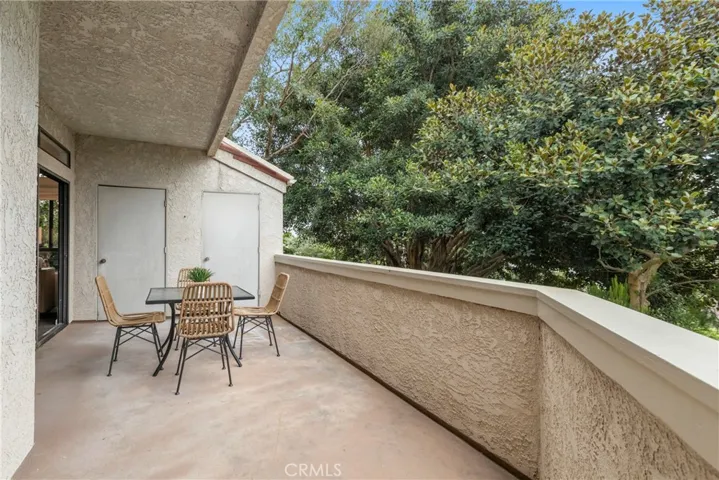 Over sized balcony with nature views. This photo has been modified. One door is to be replaced and is currently not hanging