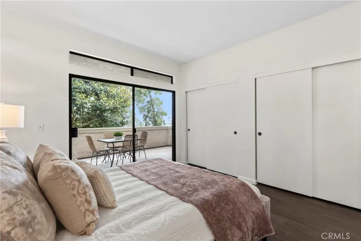 Primary Bedroom with closets and slider to the oversized balcony