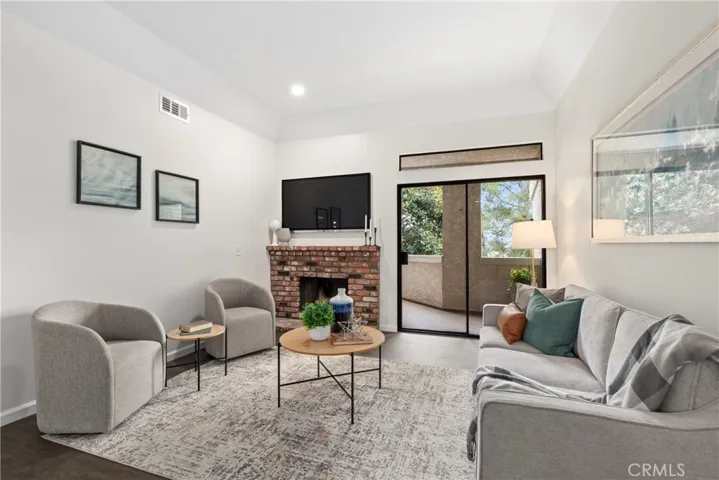Living room with gas fireplace and slider to balcony