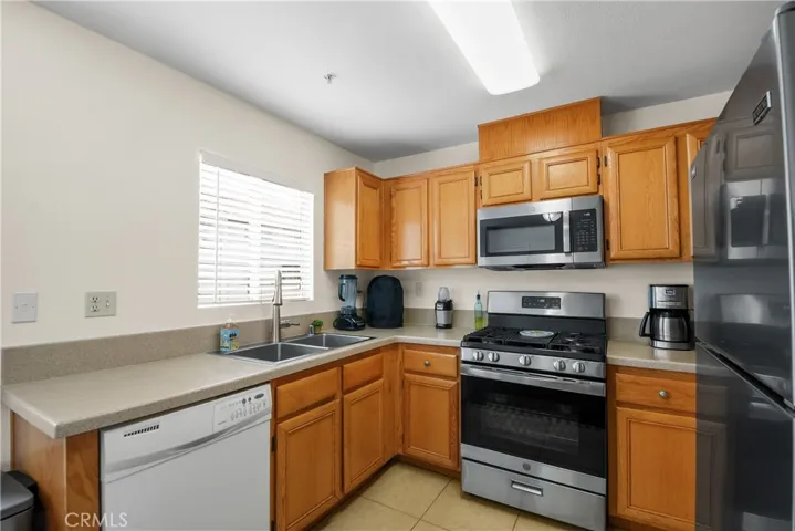 Kitchen with newer stainless steel gas range and microwave, ample counter space