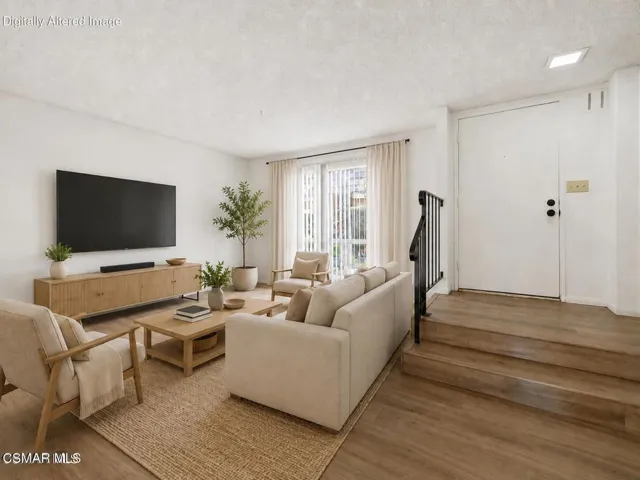 family room with TV on wall