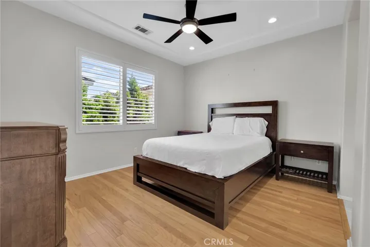 primary suite bedroom with ceiling fan