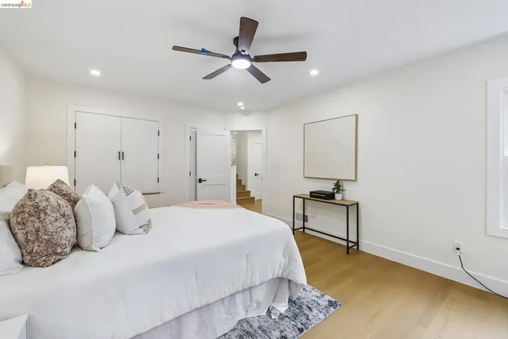 Spacious room featuring vinyl plank flooring, recessed lighting, and a ceiling fan