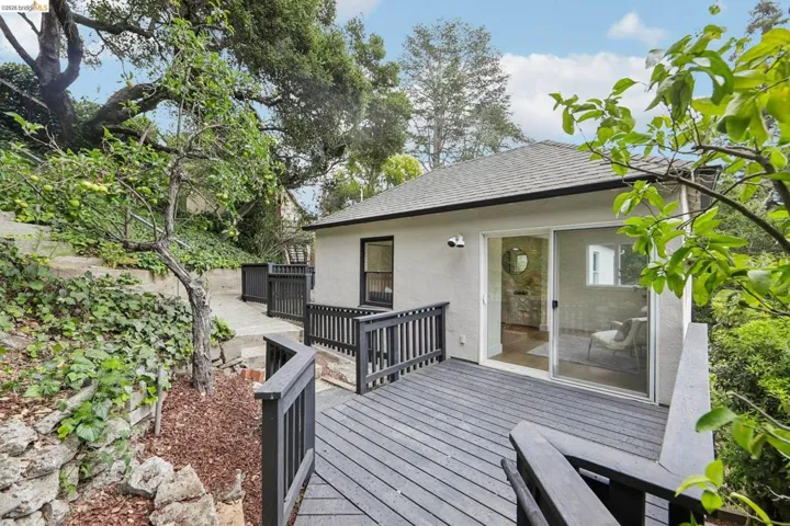 Expansive outdoor deck with dark composite flooring and railings