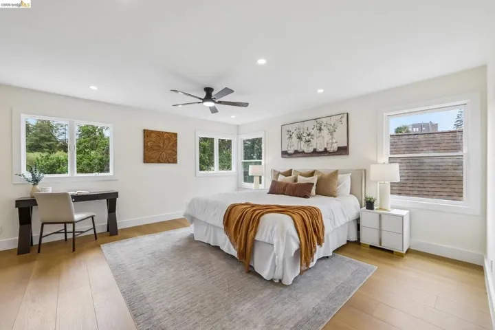 Bright room with recessed lighting and a ceiling fan