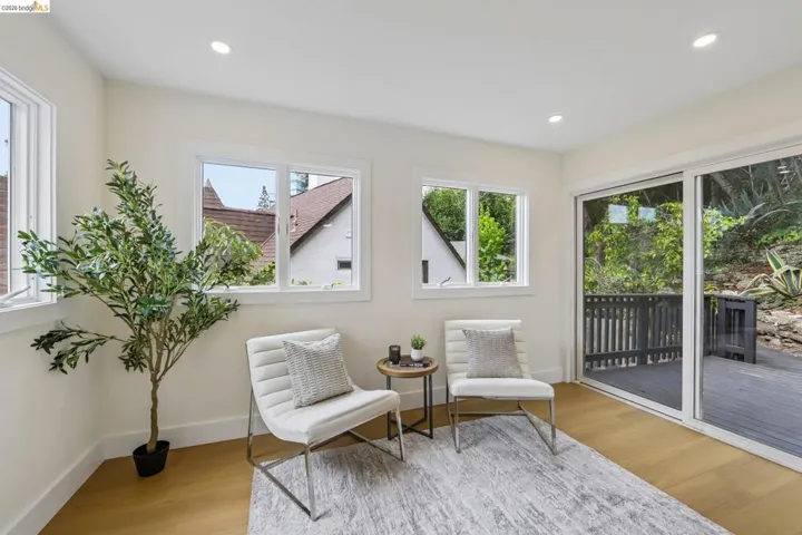 Light-filled interior space featuring vinyl plank flooring, recessed lighting, and white trim