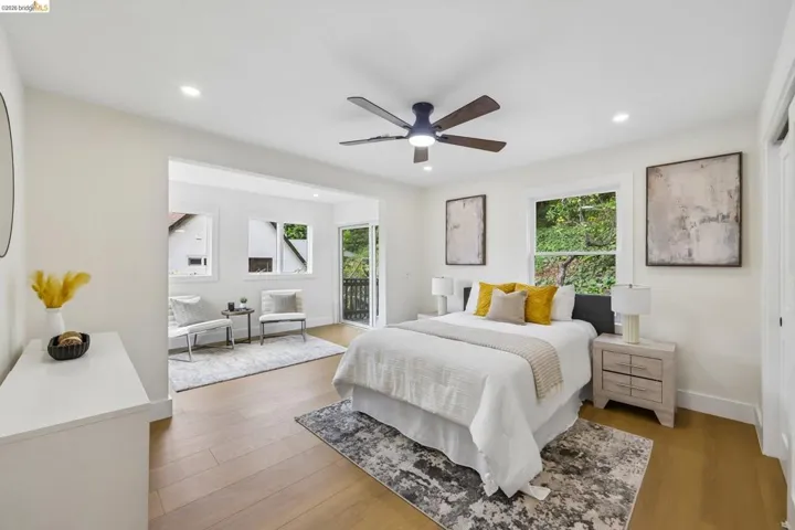 Spacious room featuring vinyl plank flooring, recessed lighting, and a ceiling fan