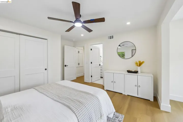 Light vinyl plank flooring complements the crisp white walls and doors