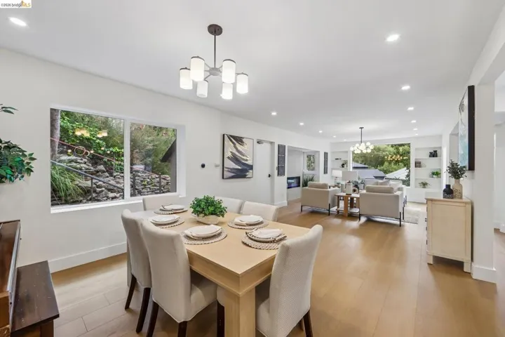 Dining area with vinyl plank flooring and a contemporary chandelier