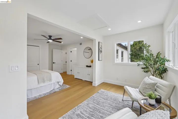 Bright interior space with vinyl plank flooring, recessed lighting, and white walls