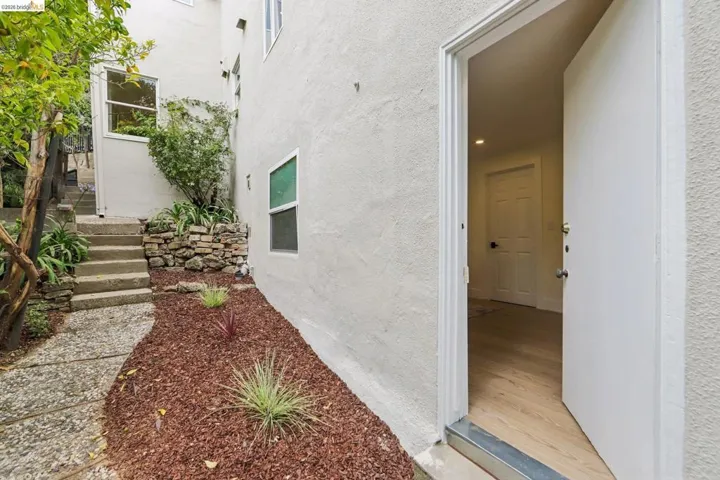 Entryway featuring a white door, vinyl plank flooring, and recessed lighting
