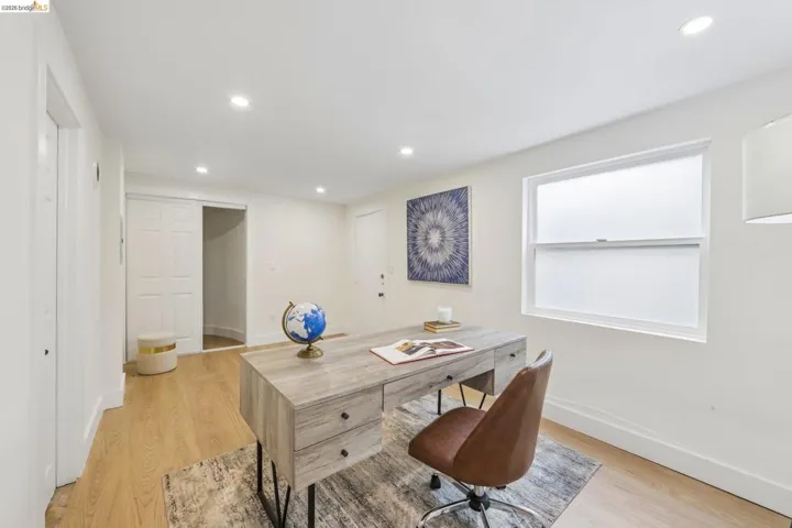 Bright room featuring vinyl plank flooring, recessed lighting, a single window