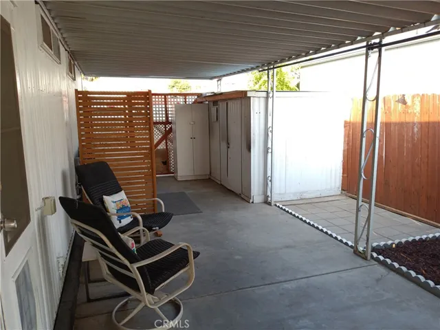 BACK COVERED PATIO WITH 2 SHEDS !!