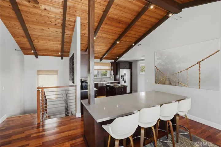 At the top of the stairs the soaring wood plank ceilings and Brazilian Tigerwood flooring bathed in natural light demands your attention in every direction. You will be greeted by the views and the kichen will to your left. It will not disappoint.