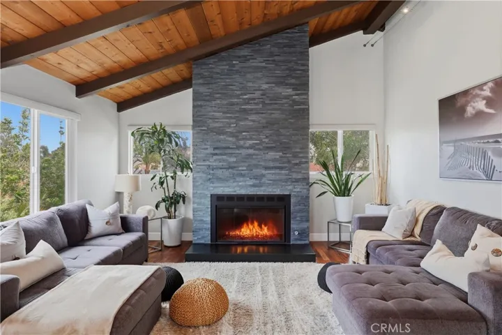 Notice all the natural light that enhances the openness of the room with soaring ceilings.