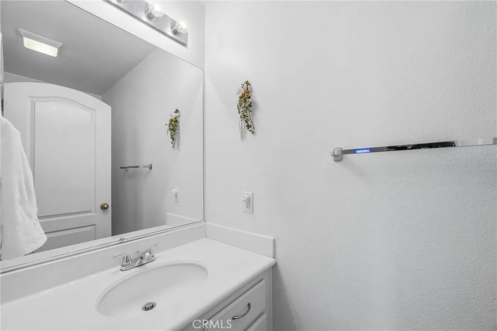 Convenient half bath with a spacious vanity and large mirror. Convenient half bath with a spacious vanity and large mirror.