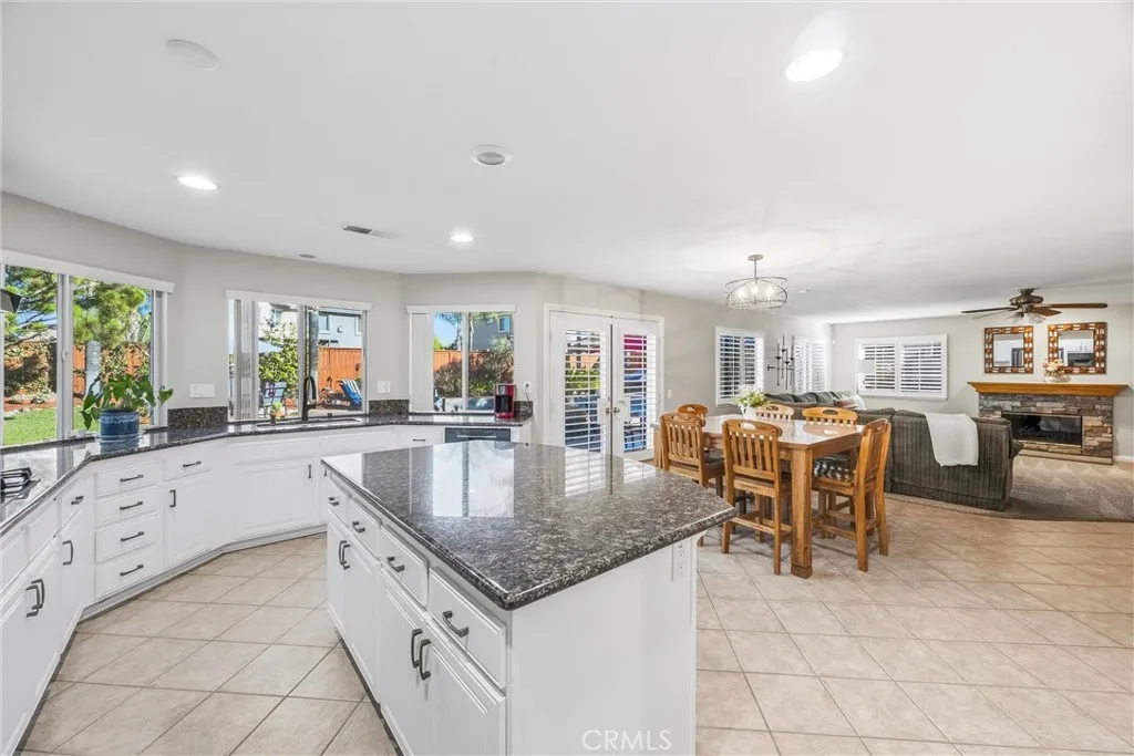 Open-concept kitchen with a spacious center island overlooking the dining and family areas. Open-concept kitchen with a spacious center island overlooking the dining and family areas.