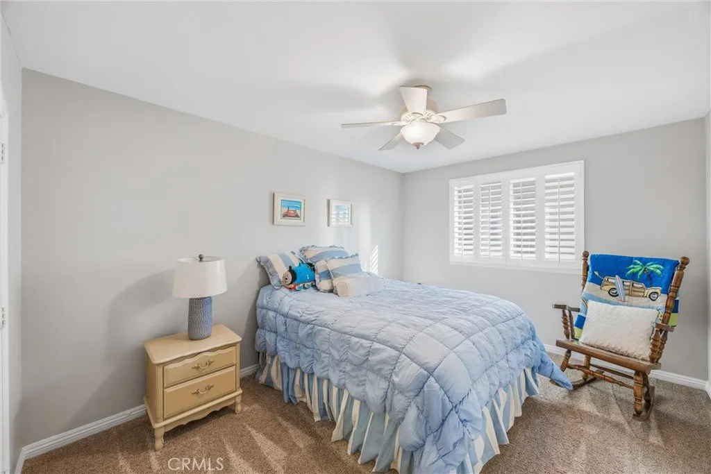 Welcoming bedroom with natural light, neutral finishes, and a ceiling fan for added comfort. Welcoming bedroom with natural light, neutral finishes, and a ceiling fan for added comfort.