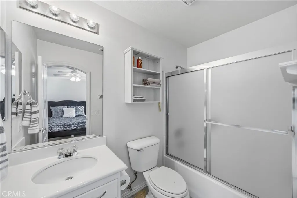 Convenient private bathroom connected to the bedroom, featuring a shower and tub combination with a sliding glass door. Convenient private bathroom connected to the bedroom, featuring a shower and tub combination with a sliding glass door.