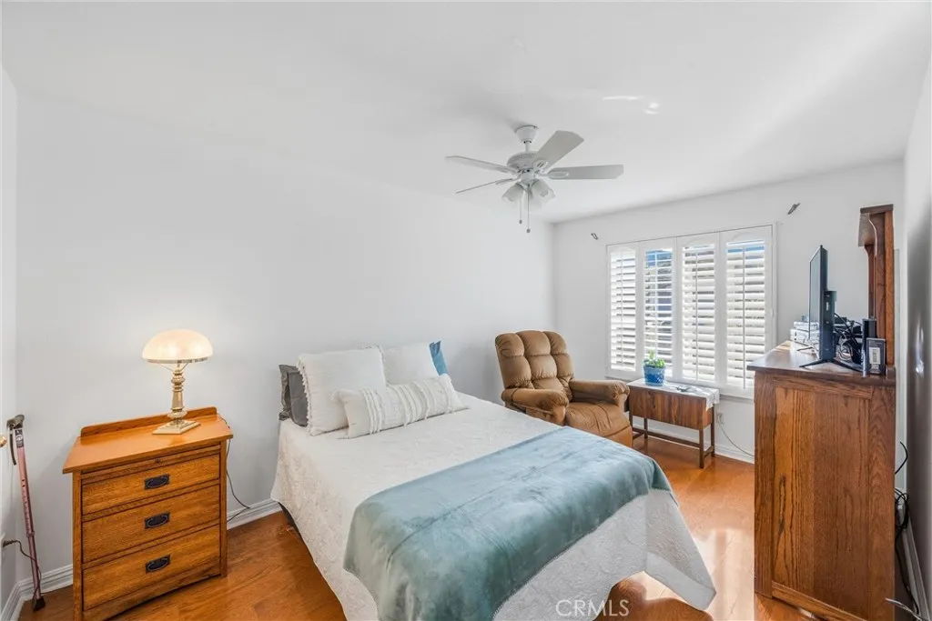 Comfortable bedroom with wood flooring, plantation shutters, Comfortable bedroom with wood flooring, plantation shutters,