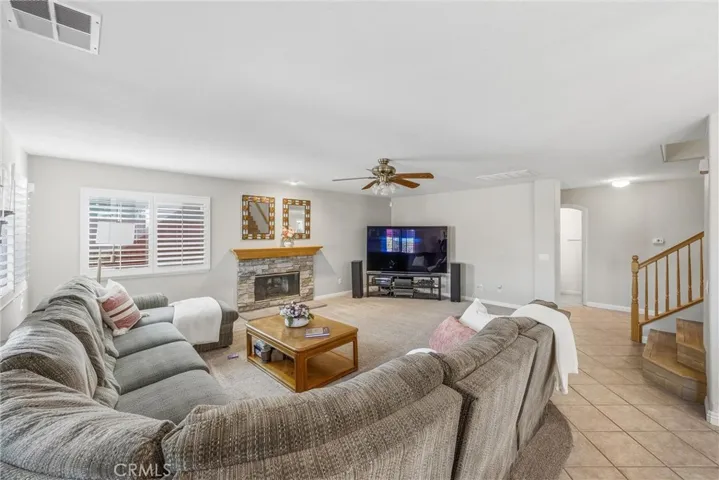 Spacious family room featuring a stone fireplace and plenty of room to relax.