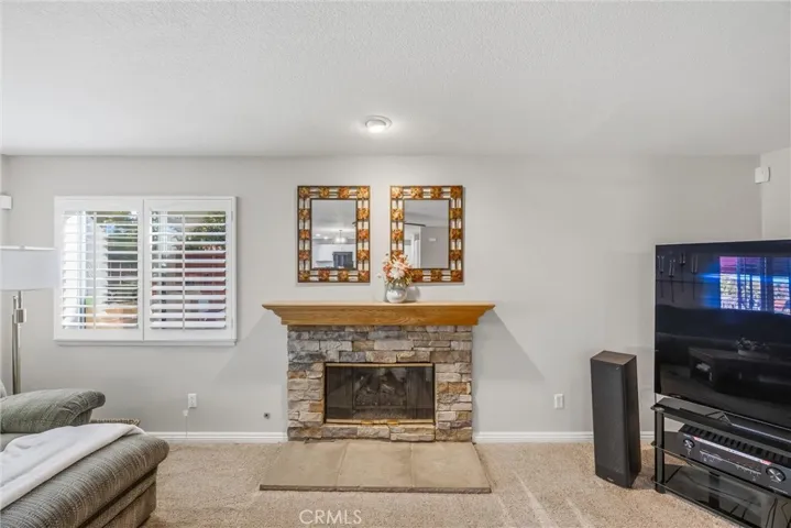 Charming stone fireplace with a wood mantel, creating a warm and inviting focal point.