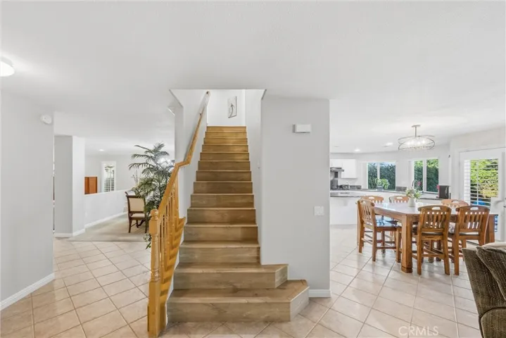 Centrally located wood staircase connecting the main living areas to the upper level.