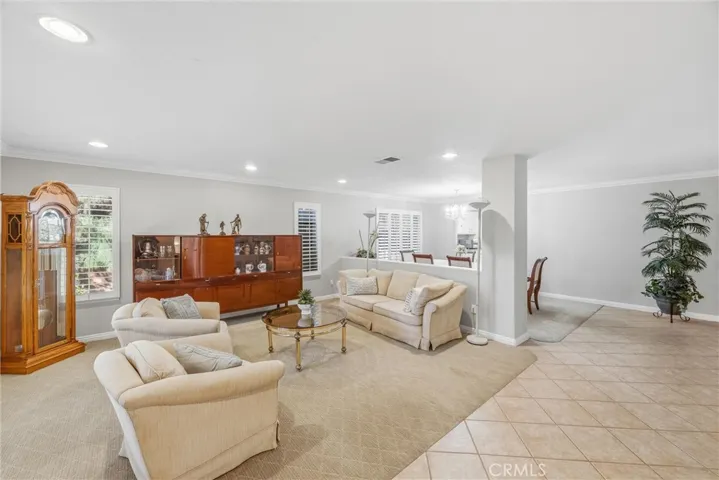 Welcoming entryway opens to a spacious living room with natural light and an inviting atmosphere.