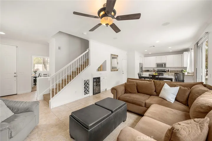 Built-in wine storage, easy to maintain tile floors, in-ceiling surround sound speakers and ceiling fan. The room in the distance is bedroom #1.