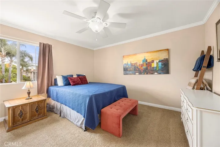 The third bedroom offers the perfect combination of space and functionality, complete with crown molding, a ceiling fan, and a walk-in closet.