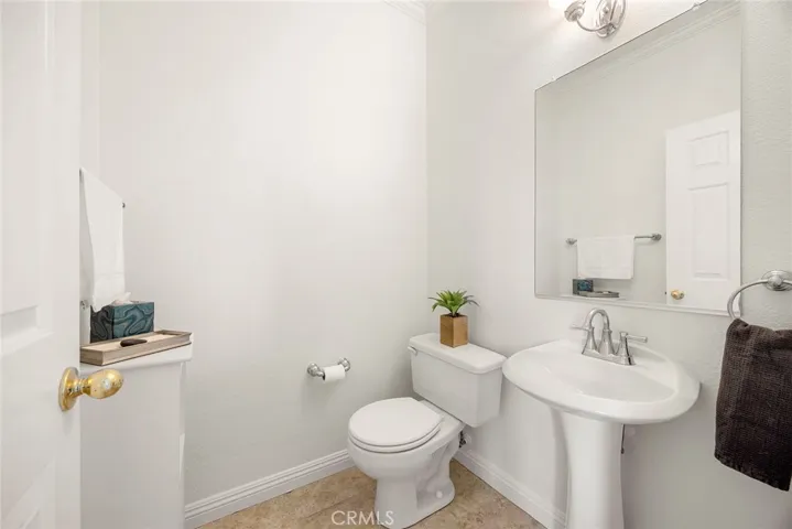 The downstairs powder room is ideally situated next to the first-floor bedroom, making it an excellent setup for guests or a home office.