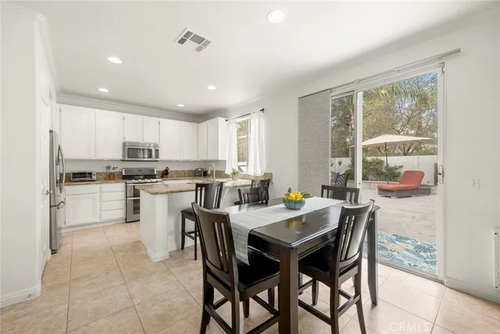Gather around the table or enjoy casual meals at the breakfast bar in this bright kitchen with direct access to the backyard for effortless entertaining.
