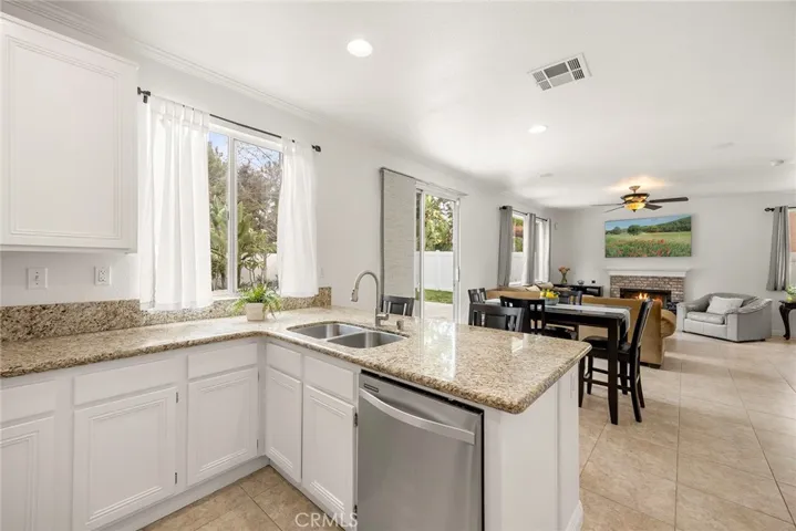 If a formal living or dining room isn't on your wish list, you'll love this open-concept floor plan. It offers seamless flow between the kitchen, dining, and living areas, with a sliding glass door that opens to the backyard for easy indoor-outdoor living.