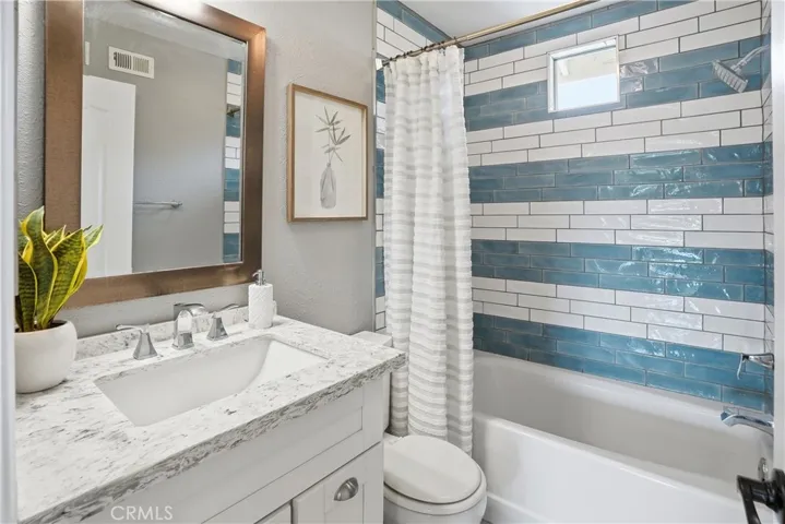More quality finishes in this upstairs hallway bathroom with shower over tub tile enclosure.