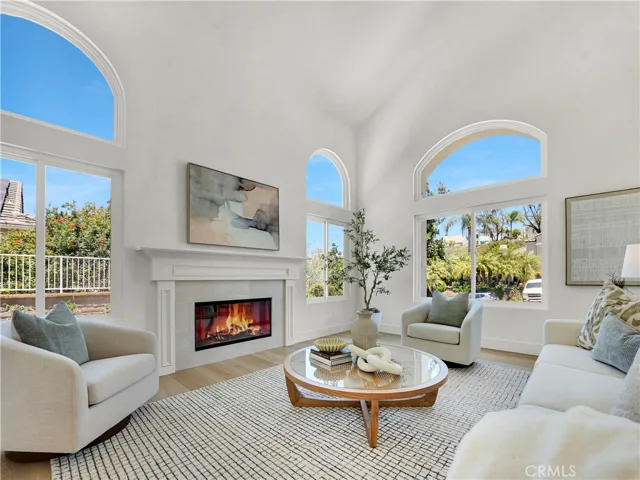 Enjoy gatherings in the generously-sized living/dining area graced by a fireplace, wine cooler, huge windows and glass sliding doors that lead out to the rear deck. Fire virtually added