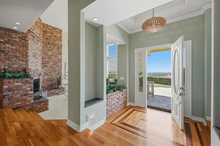 Grand entrance with custom inlaid decorative wood flooring