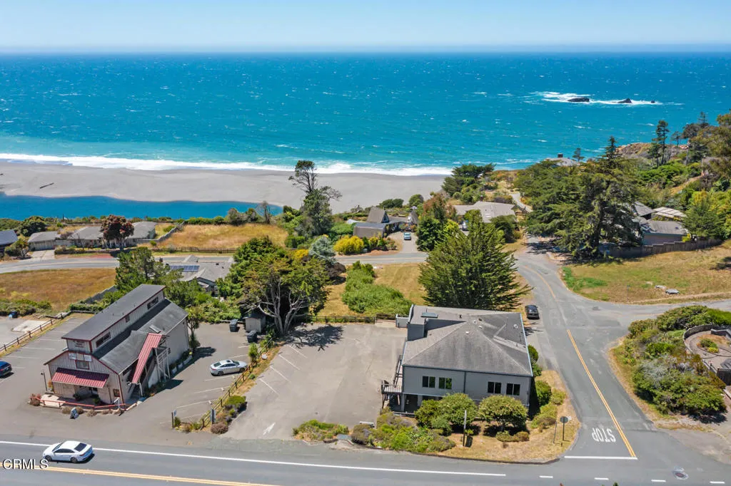 Drone view of ocean behind building and