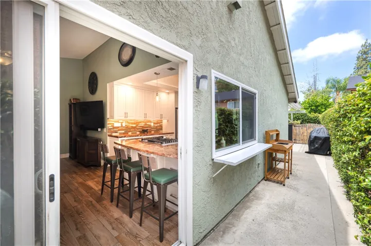 Step through the family room to easily access the side area with pass thru window for BBQ time