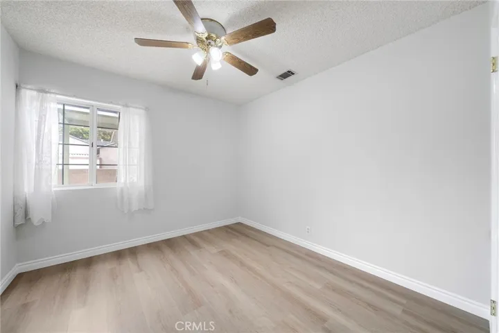 Bedroom #2. New paint and  new flooring with a ceiling fan.