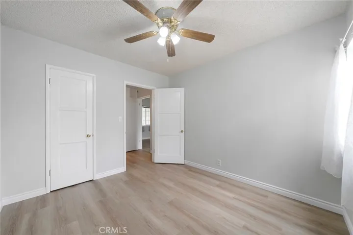 Bedroom #2. New paint and  new flooring with a ceiling fan.
