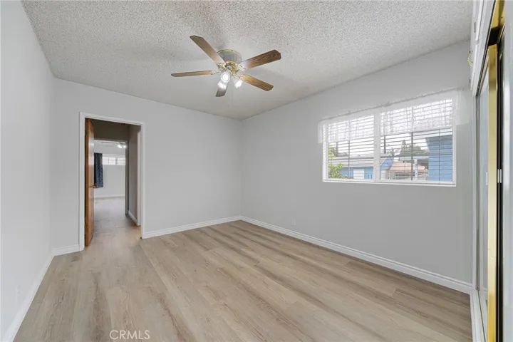 Bedroom #3 has mirrored closet doors and a ceiling fan.