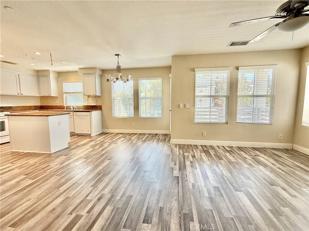 Open living kitchen/dining/living. Newer luxury vinyl flooring on stairs and second and third levels