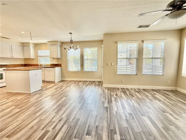 Open living kitchen/dining/living. Newer luxury vinyl flooring on stairs and second and third levels