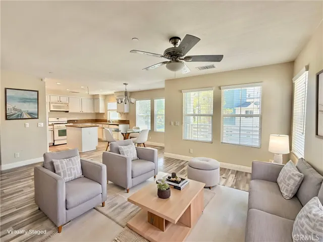 Virtually staged dining and living area - looking toward kitchen