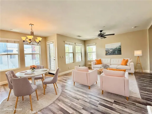 Virtually staged dining and living area - looking toward living room